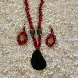 Red beaded necklace with black pendant and matching earrings